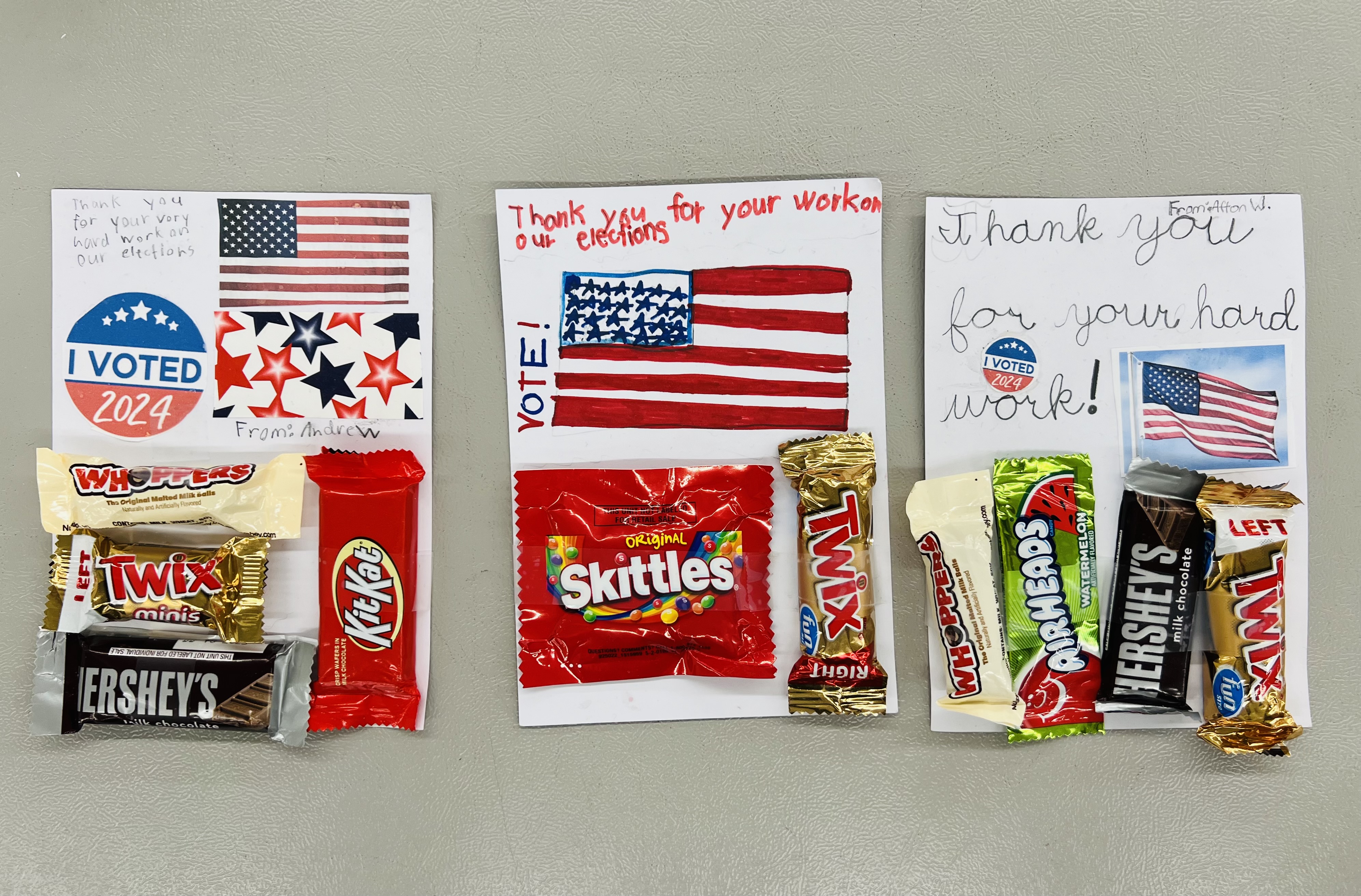 Three notes with candy taped to them from children express their thanks to election workers.