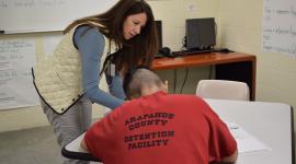 Elections workers watch as detainees at the County jail fill out their ballots