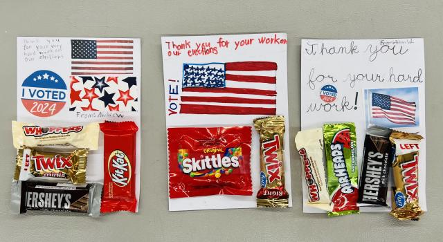 Three notes with candy taped to them from children express their thanks to election workers.